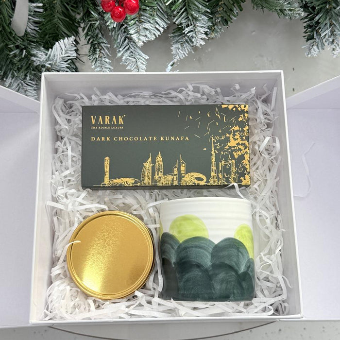 Gift box with Varak dark chocolate kunafa, a gold lid, and green packaging on a white background.