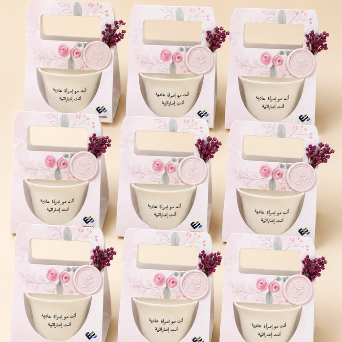 Nine identical decorative gift boxes arranged in a 3x3 grid on a light beige background. Each box is white with pink floral illustrations accents.
