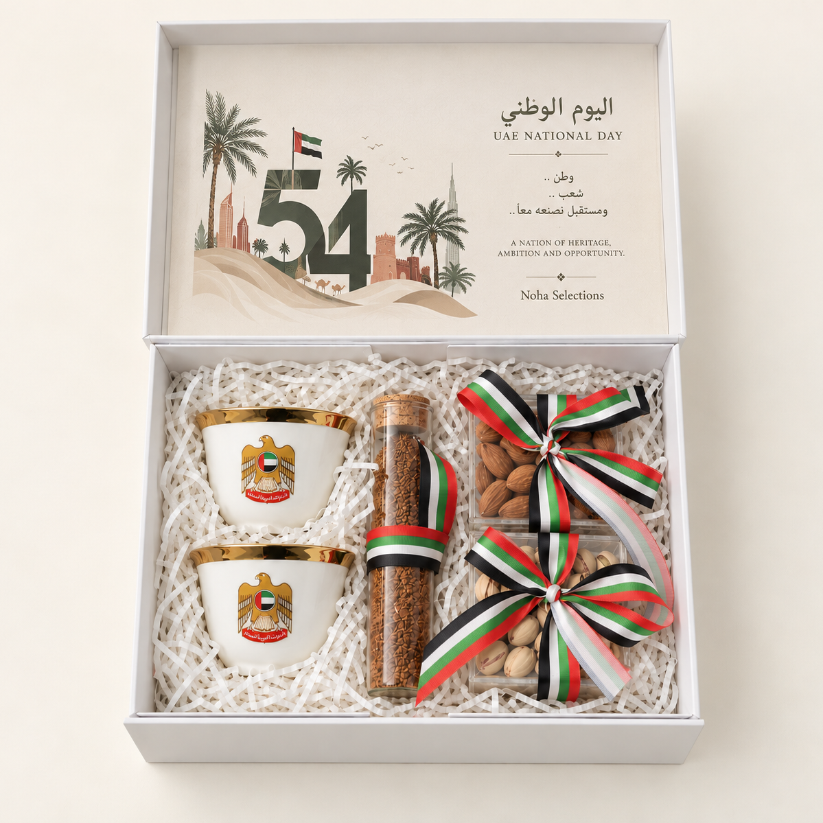 National Day Majlis UAE National Day 55 gift box featuring two heritage Arabic coffee cups, traditional coffee blend, and premium mixed nuts with National Day ribbon detailing by Noha Selections.