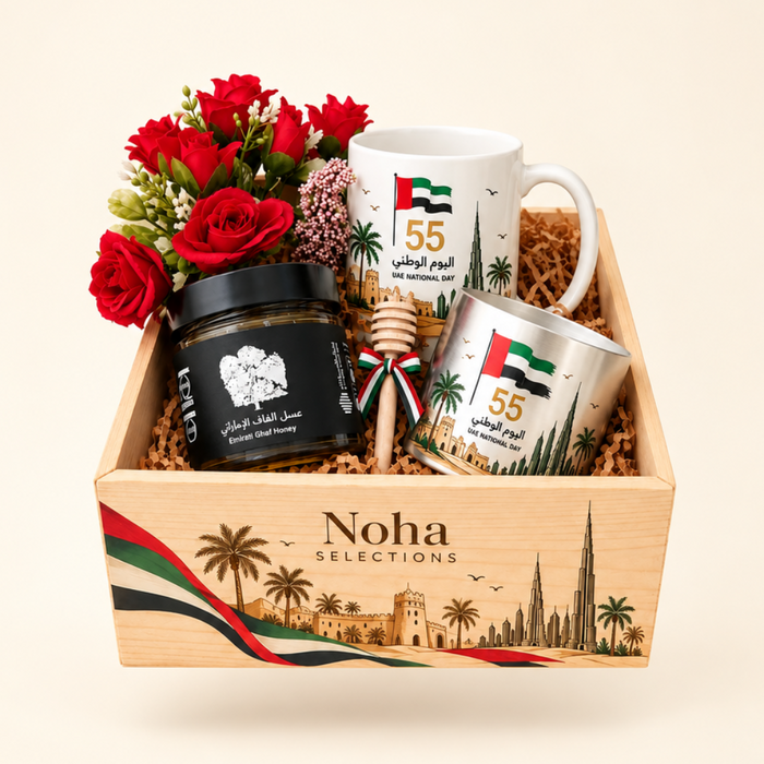 Emirati Bloom UAE National Day 55 gift box featuring a branded ceramic mug, stainless-steel cup, Emirati Ghaf honey jar with a wooden dipper, and a premium red floral arrangement inside a custom wooden presentation box by Noha Selections.