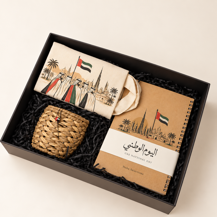 Heritage Essentials UAE National Day 55 gift box featuring a UAE-inspired canvas tote bag, spiral notebook, and handwoven heritage basket inside a premium branded presentation box by Noha Selections.