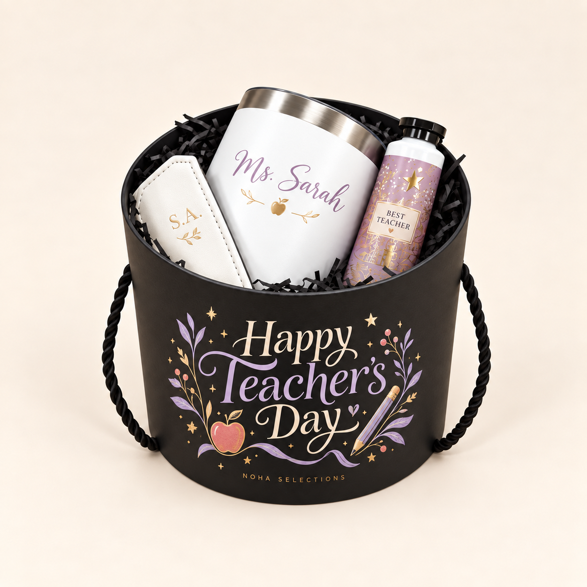 A black Teacher’s Day gift box holds a named white tumbler, an initialled white accessory, and a decorated bottle.