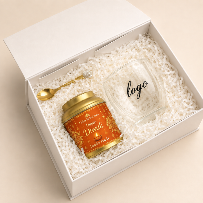 A minimalist white Diwali corporate gift box containing a glass jar with a gold lid, a small wooden spoon, and scattered dried marigold petals, featuring a custom corporate logo placeholder on the inside cover.