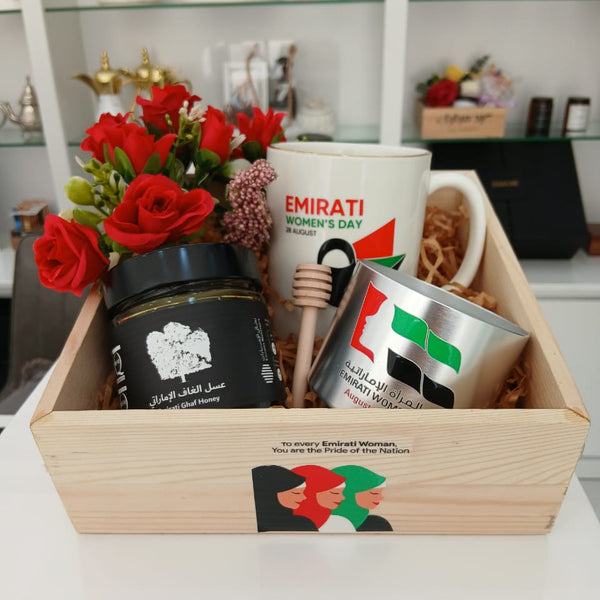 Gift basket with coffee products and flowers on a table